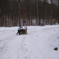 Adam and Zach sledding down after the last challenge